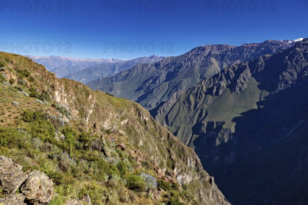 Clear sky with a wide panorama of mountains and deep gorge, The mountains and valleys of the Colca Canyon in Peru
