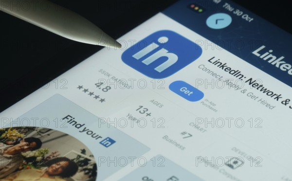 Dhaka, Bangladesh- 30 Oct 2025: LinkedIn app on a iPad screen with a pen pointing at the install option