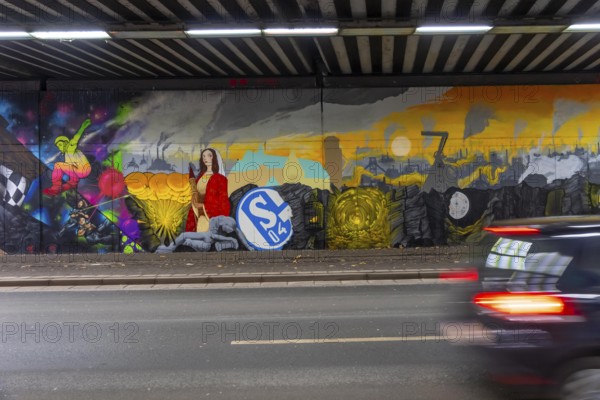 Huge street art pictures in a road tunnel in Gelsenkirchen, the approximately 120 meter long railway underpass of Wickingstraße was extensively painted and sprayed on both sides by 11 Gelsenkirchen graffiti artists and collectives, over a total length of 174 meters, the wall paintings showed motifs from Gelsenkirchen history, from economy, coal, steel, soccer, Schalke 04, culture, life, to the 150.year-old city Anniversary on 29.11.25, North Rhine-Westphalia, Germany