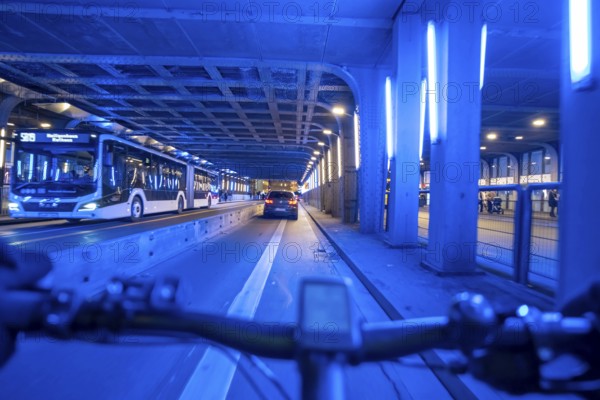Cycling in the city, in the dark, in the evening, cycling underpass at the main train station, in downtown Essen, North Rhine-Westphalia, Germany