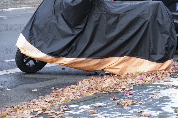 Motor scooter with cover, late autumn, Germany