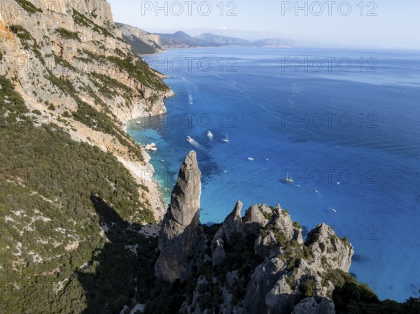 Picturesque rocky coast, cliffs with L'Aguglia pinnacle, blue sea and Cala Goloritzé beach, aerial view, Golfo di Orosei, Baunei, Sardinia, Italy
