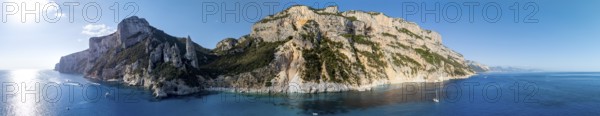 Panorama, picturesque rocky coast, cliffs with L'Aguglia pinnacle, blue sea and Cala Goloritzé beach, aerial view, Golfo di Orosei, Baunei, Sardinia, Italy