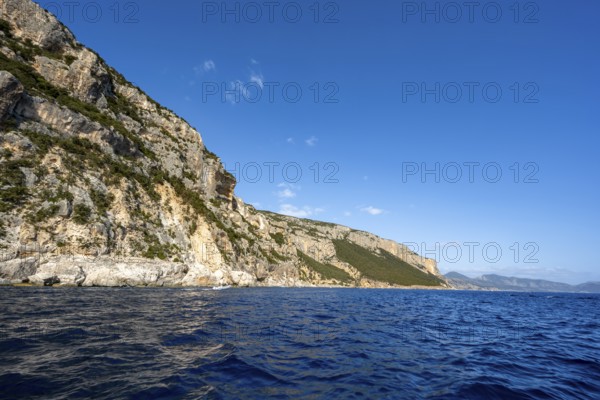 Picturesque rocky coast, cliffs in morning light, blue sea, Golfo di Orosei, Baunei, Sardinia, Italy