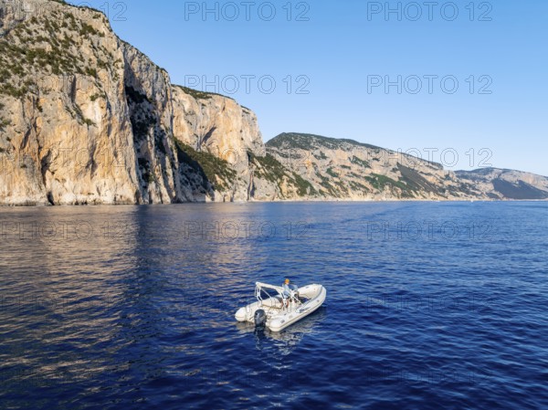 Motorboat off picturesque rocky coast ImmorgenLicht, cliffs, Golfo di Orosei, Baunei, Sardinia, Italy