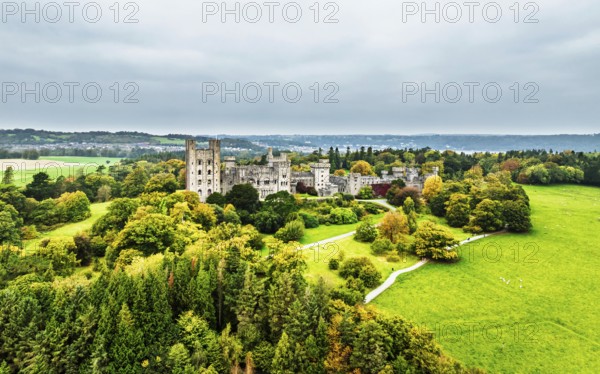 Autumn colours over Penrhyn Castle and Garden from a drone, Llandygai, Bangor, Gwynedd, North Wales, UK