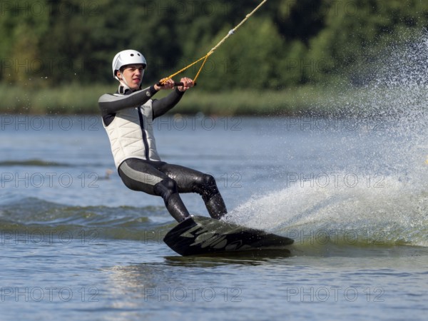Young man with wakeboard, sporty on water, athletic model, active water sports, wake park