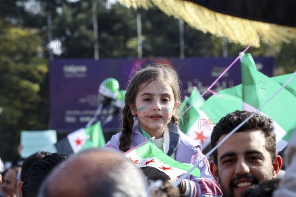 Damascus, Syria. November 28, 2025: Thousands of Syrians gather in Umayyad Square in central Damascus to celebrate the anniversary of the military operation that led to the fall of Bashar al-Assad's regime. Demonstrators express joy and unity while denouncing Israeli attacks on Syrian territory, Damascus, Damascus, Syria