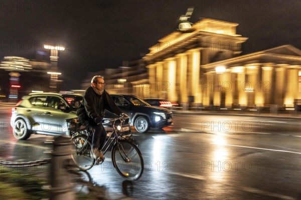 Cyclists, evening traffic on Ebertstraße, on March 18, at Brandenburg Gate, Berlin, Germany