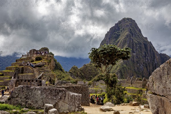 Dramatic sky over ancient ruins in front of a big mountain, The ruins of the Inca city of Machu Picchu in Peru