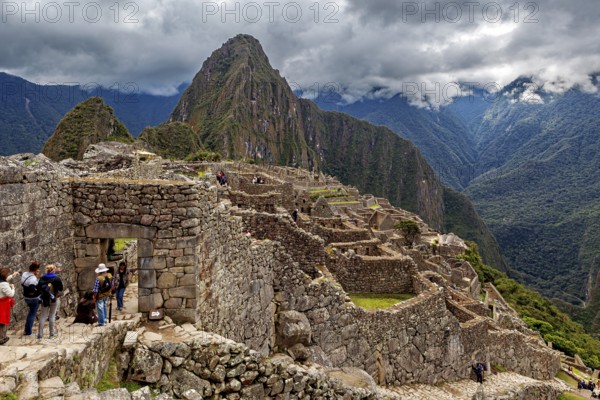 Machu Picchu ruins against a majestic backdrop of mountains and clouds, The ruins of the Inca city of Machu Picchu in Peru