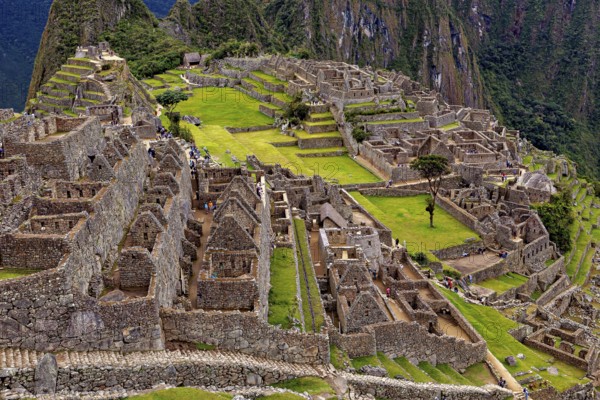 Rocky ruins and expansive terraces in an ancient setting, the ruins of the Inca city of Machu Picchu in Peru