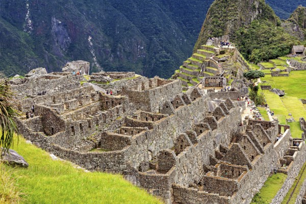 Stone ruins and agricultural terraces in an ancient urban landscape, The ruins of the Inca city of Machu Picchu in Peru
