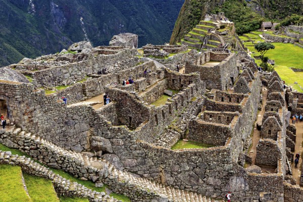 Stone Inca ruins of Machu Picchu surrounded by mountainous landscape, The ruins of the Inca city of Machu Picchu in Peru