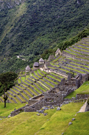 Sloping View of Stone Terraces and Huts on the Site, The Ruins of the Inca City of Machu Picchu in Peru