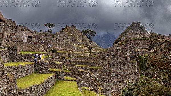 Detailed view of Machu Picchu with impressive ruins and thick cloud cover in the background, The ruins of the Inca city of Machu Picchu in Peru