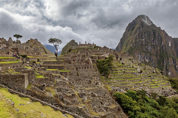 Historic ruins of Machu Picchu with impressive mountain scenery and clouds, The ruins of the Inca city of Machu Picchu in Peru