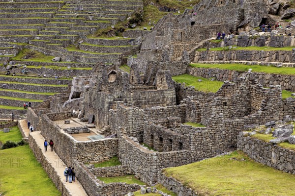 Stone walls and terraces with walking path in the Inca site of Machu Picchu, The ruins of the Inca city of Machu Picchu in Peru