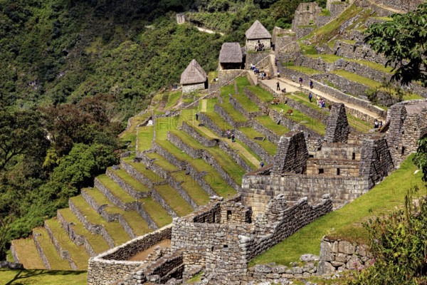 Historic Inca ruins with well-preserved terraces and huts, The ruins of the Inca city of Machu Picchu in Peru