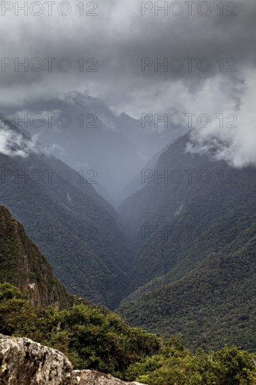 Mystical mountain landscape covered by clouds, The Urubamba Valley near Machu Picchu in Peru