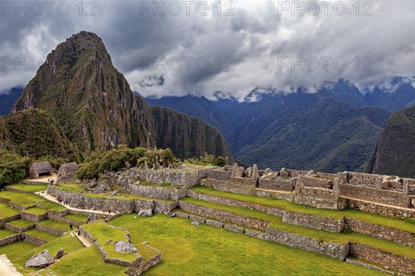 View of Machu Picchu with a mix of ruins and green terraces, The ruins of the Inca city of Machu Picchu in Peru