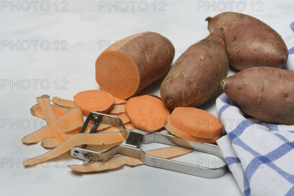 Sweet potatoes with potato peeler, potato slices, partially peeled, Ipomoea batatas
