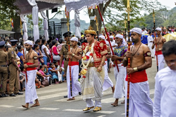 Man in royal dress leads a ceremonial procession at a cultural event, The Perahera Parade in Kandy Sri Lanka