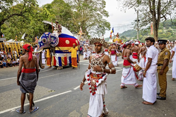 Lively festival parade with dancers, an elephant and a large crowd of spectators, The Perahera Parade in Kandy Sri Lanka