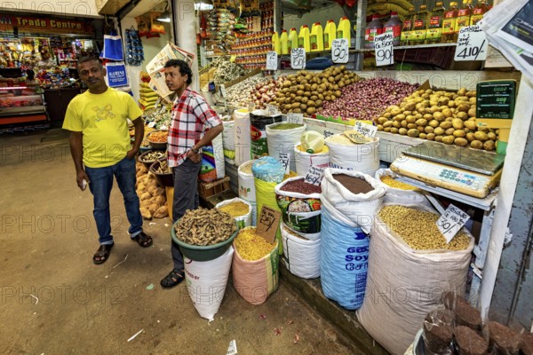 Retailers offer a variety of spices and foodstuffs, retailers in the market halls of Kandy Sri Lanka