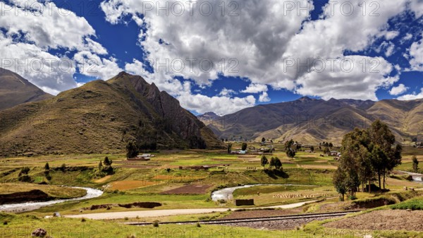 Picturesque landscape with hills, river and lush greenery under a cloudy sky, The landscape in the highlands of Peru