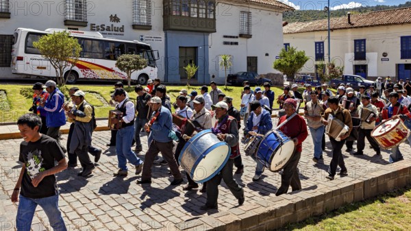 Music band with drums and other instruments marching on the street during a procession, traditional parade of festival groups in Cusco in Peru
