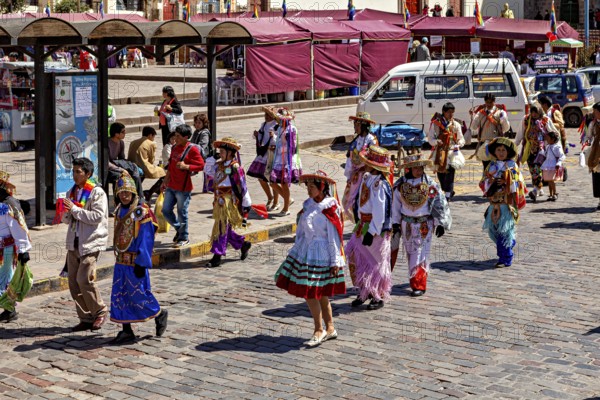 People wearing colorful costumes on a street at a parade, traditional parade of festival groups in Cusco in Peru