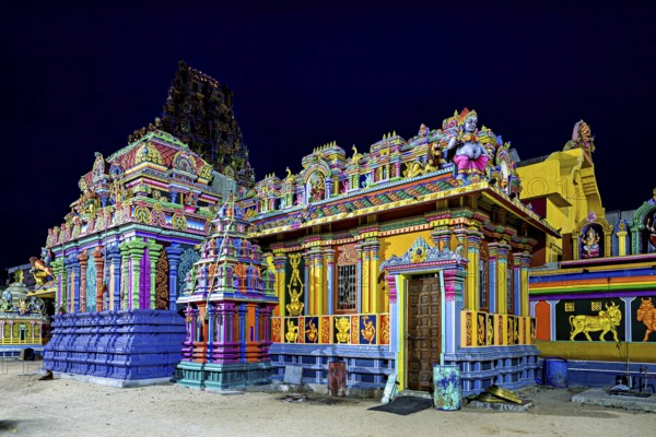 Hindu temple at night, illuminated, with intense colors and detailed architecture, The Sri Pathrakali Amman Trincomalee in Sri Lanka