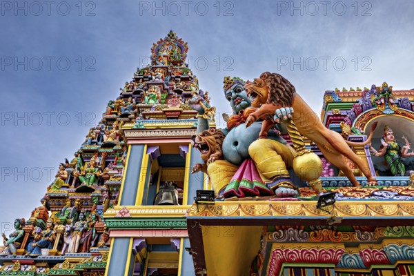Close-up of a detailed temple façade with colorful, mythological sculptures, The Sri Pathrakali Amman Trincomalee in Sri Lanka