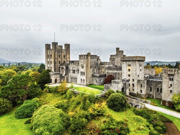 Autumn colours over Penrhyn Castle and Garden from a drone, Llandygai, Bangor, Gwynedd, North Wales, UK