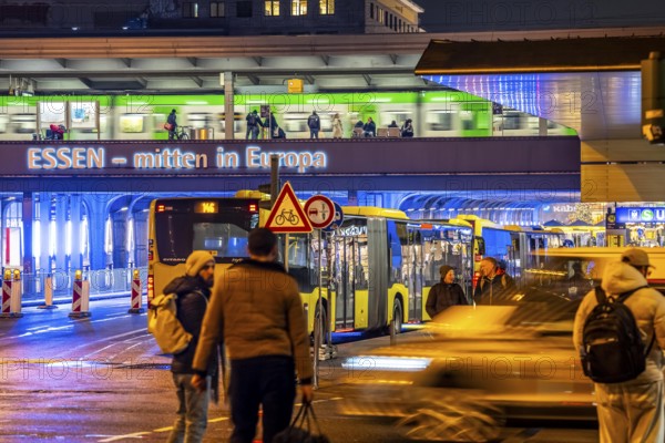 The main train station in Essen, blue illuminated underpass, bus station, am Europaplatz, train on the platform, pedestrian crossing, North Rhine-Westphalia, Germany