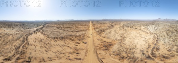 Travel, aerial view, car driving on road through arid landscape, Kunene region, Namibia