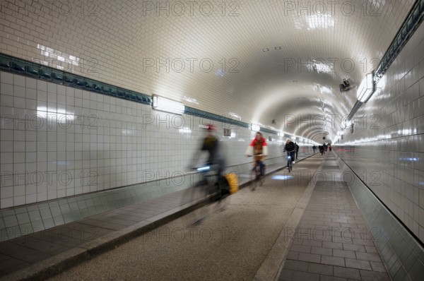 Interior view, pedestrians and cyclists crossing tunnel, mopping effect, movement, tube, historic old Elbe Tunnel, Free and Hanseatic City of Hamburg, Germany
