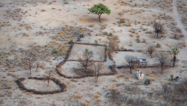 Settlement, simple house and fence, dry savanna landscape, near Maun, aerial view, Okavango Delta, Botswana