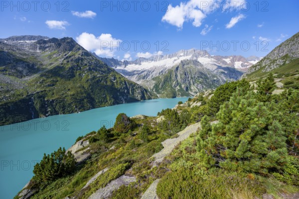 Turquoise blue mountain lake Göscheneralpsee, picturesque mountain landscape with dammastock and damma glacier, Göscheneralp, Canton of Uri, Switzerland