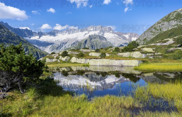 Picturesque mountain landscape, dammastock and damma glaciers reflected in Moorsee, Göscheneralp, Canton of Uri, Switzerland