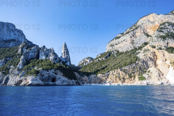 Picturesque rocky coast, cliffs with L'Aguglia pinnacle, blue sea and Cala Goloritzé beach, Golfo di Orosei, Baunei, Sardinia, Italy