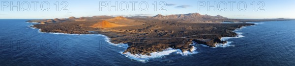 Coast with lava fields, volcanic landscape near Los Hervideros with red volcano Montaña Bermeja, in the evening light, aerial view, Lanzarote, Canary Islands, Spain