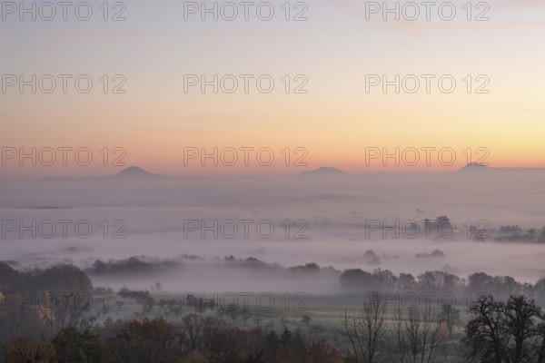 Three Kaiserberge mountains in golden morning light, Hohenstaufen, Aichelberg. Spectacular dawn over the foggy foothills of Baden-Württemberg