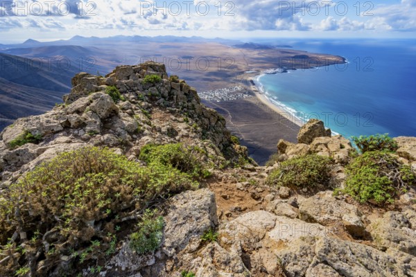 Castillejo viewpoint, view from the Risco de Famara cliffs to the coast and the sea with the Famara beach, Playa de Famara, Lanzarote, Canary Islands, Spain
