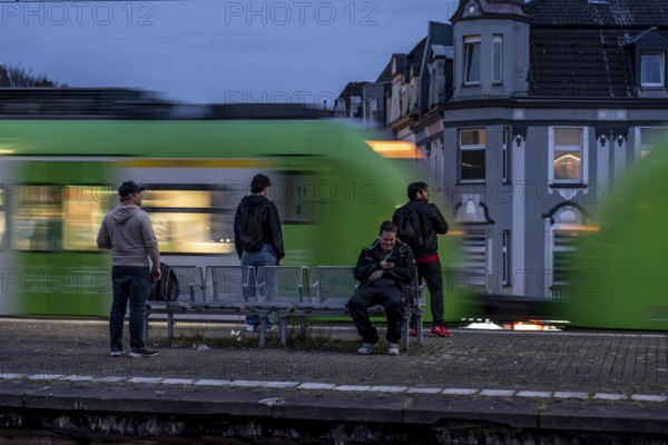 Essen-Steele S-Bahn station, passengers waiting for the train late afternoon, in autumn, Essen, North Rhine-Westphalia, Germany