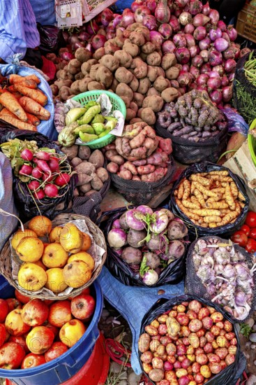 Colourful market image with a variety of fresh fruit and vegetables, including potatoes, onions and carrots, fruits and vegetables at the Rurrenabaque market in Bolivia