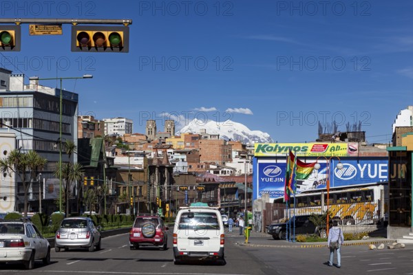 Urban street with traffic and billboards, mountains can be seen in the background, The city of La Paz in Bolivia