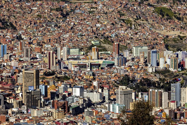 View of a dense urban landscape with many skyscrapers and mountains in the background, The city of La Paz in Bolivia