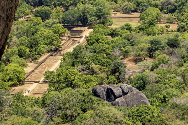 Aerial view of historic ruins and lush jungles with rock formations, the temples, dagobas, and pagodas at Lion Rock near Sigiriya in Sri Lanka